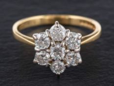 An 18ct gold, round, brilliant-cut diamond cluster ring,: of flowerhead design,