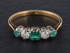 An emerald and round, brilliant-cut diamond five stone ring,: total diamond weight ca. 0.