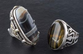 Two gemset rings,: including cabochon-cut banded agate and tiger's eye, length of ring heads ca.
