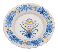 A French faience dish and one other: the former of footed lobed form painted in ochre,