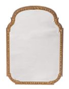 A Continental carved and giltwood framed wall mirror, 19th century,: of shallow arched form,