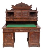 A Chinese carved wood pedestal desk, early 20th century,: with all over decoration of flowers,