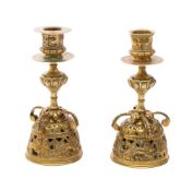 A pair of 16th century style brass candlesticks: with foliate decorated sconces,