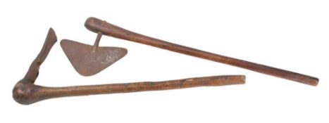 A hand axe: with arrow-shaped steel blade on a slender tapering hardwood handle, 65cm long,