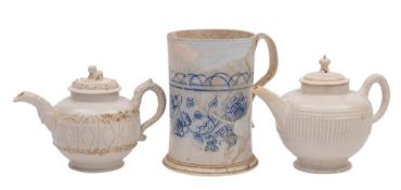 Two Staffordshire white saltglaze teapots and covers and a scratch-blue mug: the first with serpent