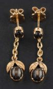 A pair of cabochon-cut star brown sapphire drop earrings of foliate design,