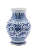 A Chinese blue and white baluster vase: painted in Ming style with scrolling lotus and peony