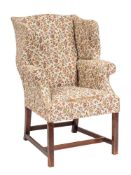 An upholstered wing armchair in George II style, second half 19th century,