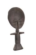 An Ashanti Akua-ba figure: of stylised design with large circular head and tapering body, 32cm high.