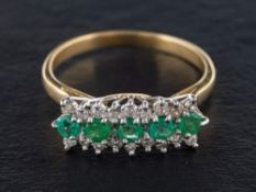 An emerald and diamond three-row ring,: estimated total diamond weight ca. 0.