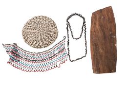 A cowrie shell decorated circular mat: 22.