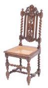 A carved oak and canework chair in Charles II style, late 19th century,