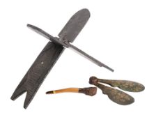 An African carved hardwood folding seat: decorated with fish carved in low relief, 45cm long,