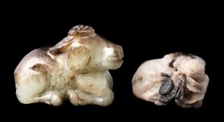A Chinese jade carving of a reclining buffalo and one other: the first of celadon and grey/russet