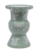 A Chinese celadon ground vase: of 'Gu' form, enamelled in low relief with white flowers and fruit,