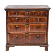 A George I oak and walnut banded chest of drawers, circa 1725.