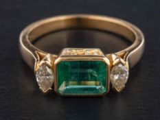 A three-stone, emerald and marquise-cut diamond ring,: calculated weight of emerald ca. 1.