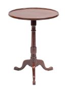 A George III mahogany tripod table, circa 1770,: the circular top with moulded edging,