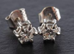 A pair of round, brilliant-cut diamond ear studs,: total estimated diamond weight ca. 0.