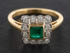An 18ct gold step-cut emerald and round, brilliant-cut diamond cluster ring,