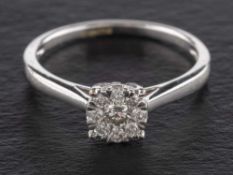 A round brilliant-cut diamond cluster ring,: the central diamond estimated weight ca. 0.