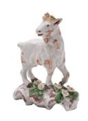 A Plymouth polychrome model of a goat: standing on a raised mound base applied with flowers and