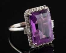 An 18 carat gold amethyst and diamond dress ring: the central rectangular step cut amethyst