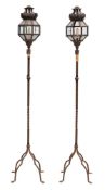 A pair of wrought iron standard lanterns:,