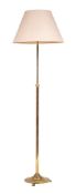 A brass adjustable standard lamp, 20th century,: the telescopic shaft above a circular base,