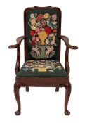 A mahogany and upholstered elbow chair in George II style,