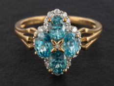 A 9ct gold, quartrefoil, blue zircon and diamond cluster ring,: estimated total diamond weight ca.