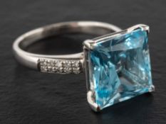 A step-cut blue topaz and diamond ring,: estimated weight of topaz ca. 12.