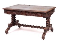 A George IV or William IV carved oak library table, in the manner of designs by Anthony Salvin,