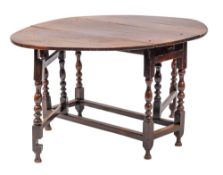 A Charles II oak gateleg table, circa 1665,: the oval top with twin drop leaves; on baluster,