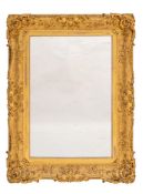 A rectangular gilt composition frame in Louis XV transitional style, now fitted as a wall mirror,