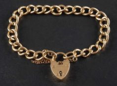 A 9ct gold curb-link bracelet with heart-shaped clasp,: with hallmarks for Birmingham, 1963,