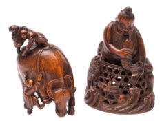 A pair of Chinese carved bamboo groups: one in the form of a bearded fisherman astride a large