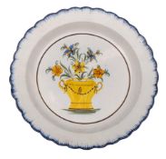 An early 19th century pearlware plate: painted in Pratt colours with an urn of flowers within a