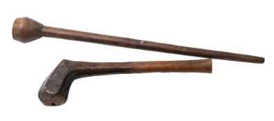 A tribal hardwood club: the pommel end with incised geometric pattern decoration, on tapering shaft,