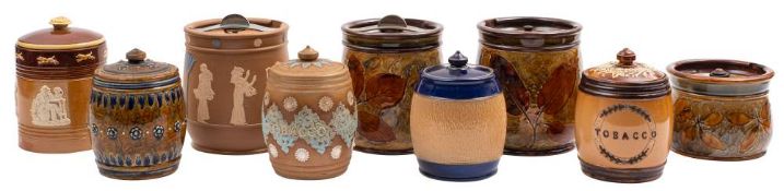 Nine Doulton stoneware tobacco jars: comprising three Natural Foliage Ware examples, two Silicone,