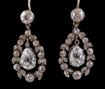 A pair of pear-shaped, old and single-cut diamond drop earrings,: the pear-shaped diamonds,