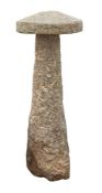 A large granite staddle stone and cap,