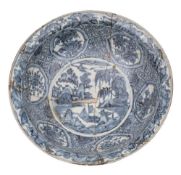 A large Chinese Swatow blue and white basin: painted with a medallion of trees,
