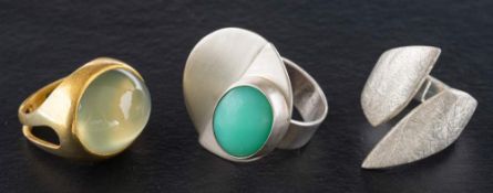 Three rings,: a cross-over ring with textured surface,