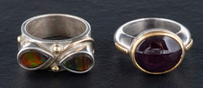 Two gemset rings,: one set with a cabochon-cut, purple,