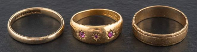 Three gold rings,: including a Victorian, 18ct gold, ruby set ring, with hallmarks for Birmingham,