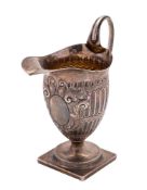 A Victorian silver cream jug, maker Charles Stuart Harris, London, 1881: of helmet-shaped outline,