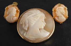 A shell cameo brooch and pair of ear clips,: both depicting a lady in profile,