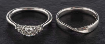 Two platinum rings,: including a round, brilliant-cut diamond ring,