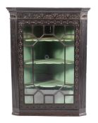 A Victorian carved oak and glazed hanging corner cabinet, last quarter 19th century,